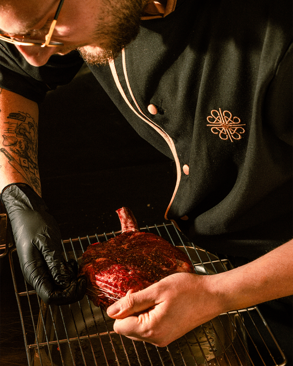 Chef preparing a cut of meat in the kitchen